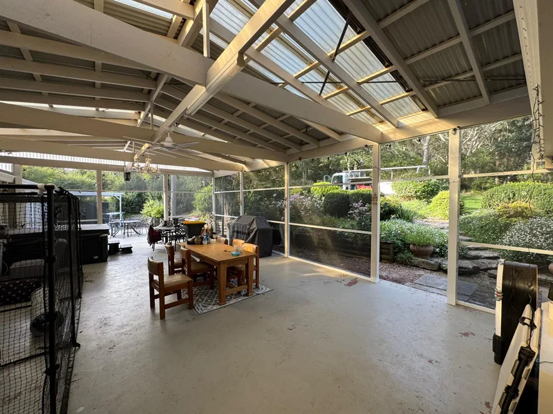 Enclosed alfresco set up as a year-round living room — Narellan, NSW