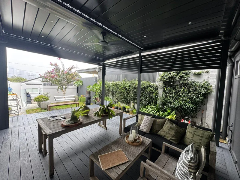Timber deck beneath an opening louvre roof — Harrington Park, NSW