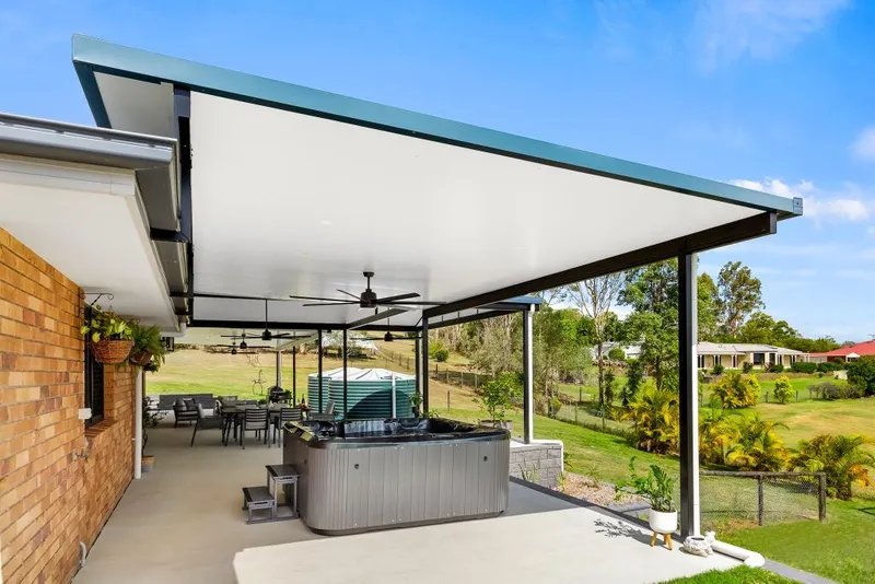 Flyover patio opening up light over a rear alfresco — Parramatta, NSW
