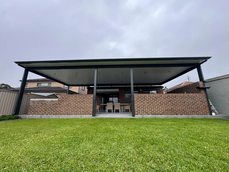 Wide flyover patio spanning the rear of a brick home — Blacktown, NSW