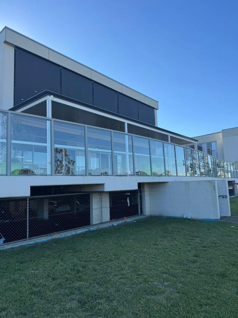 Patio with glass balustrade overlooking the grounds — Caringbah, NSW