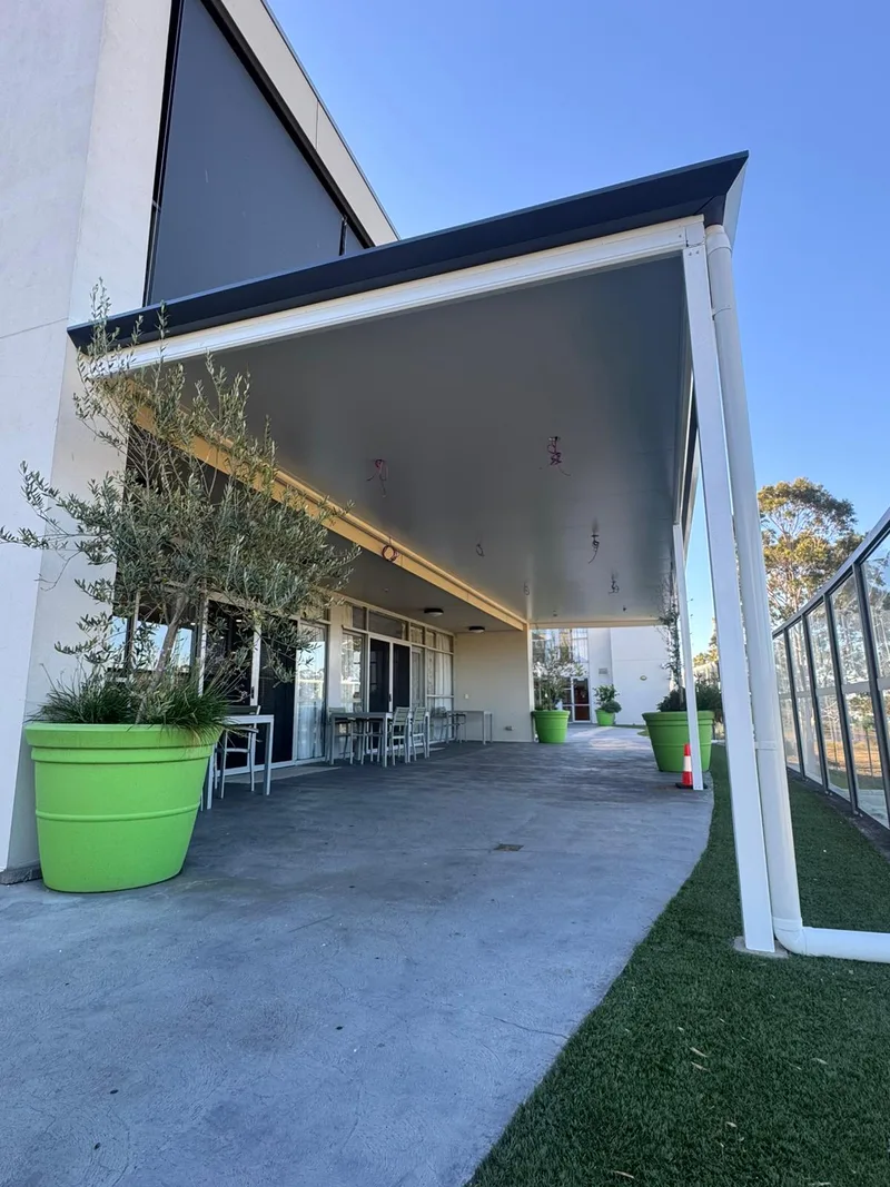 Flyover insulated patio shading a large alfresco area — Kiama, NSW