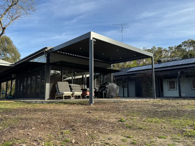 Opening louvre roof shading a poolside entertaining area — Wollongong, NSW