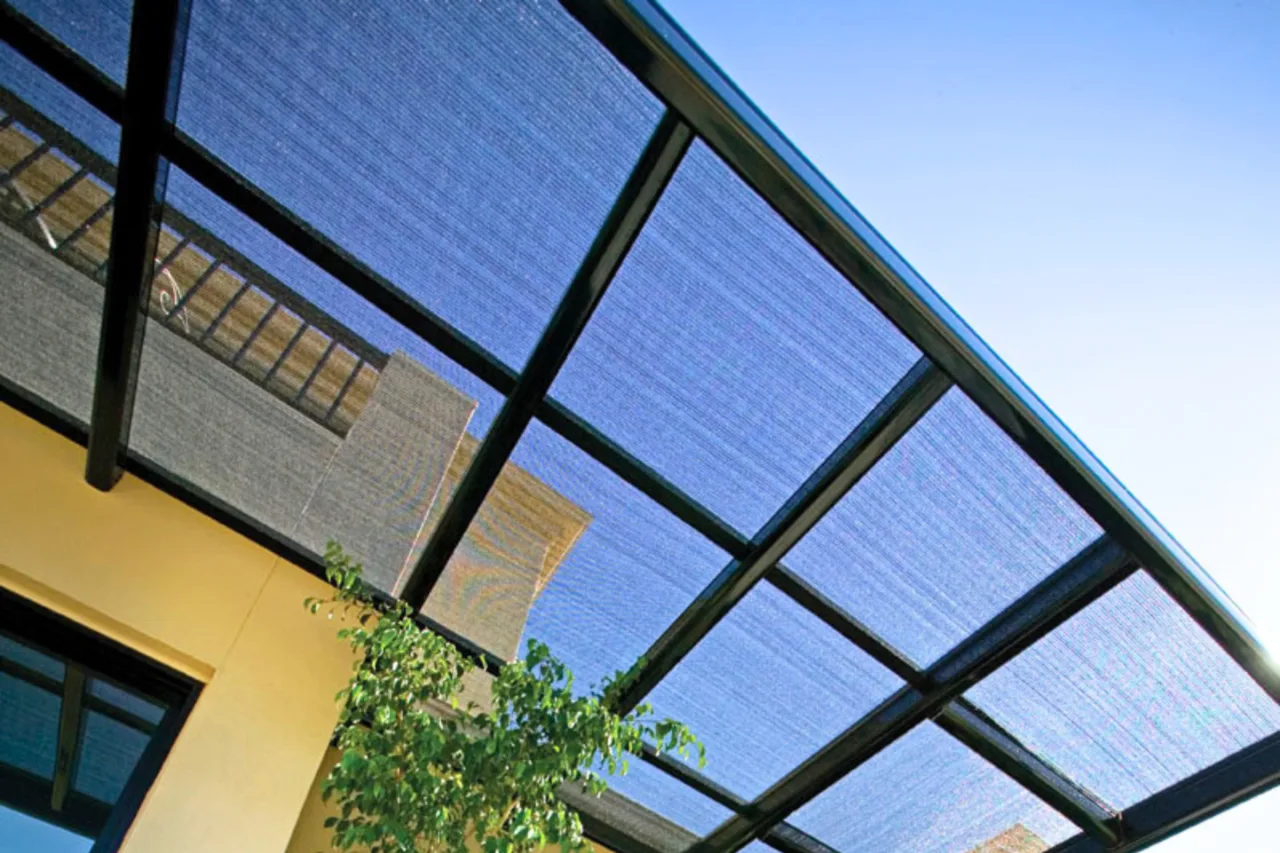 Tinted polycarbonate flat-roof pergola against a rendered wall — Parramatta, NSW