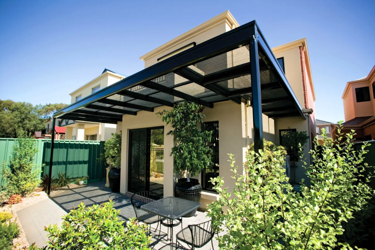 Black-framed pergola with shade mesh over a paved courtyard — Caringbah, NSW