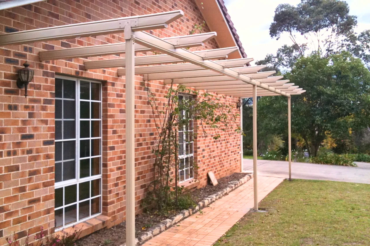 Open pergola running along a brick facade out to the driveway — Camden, NSW